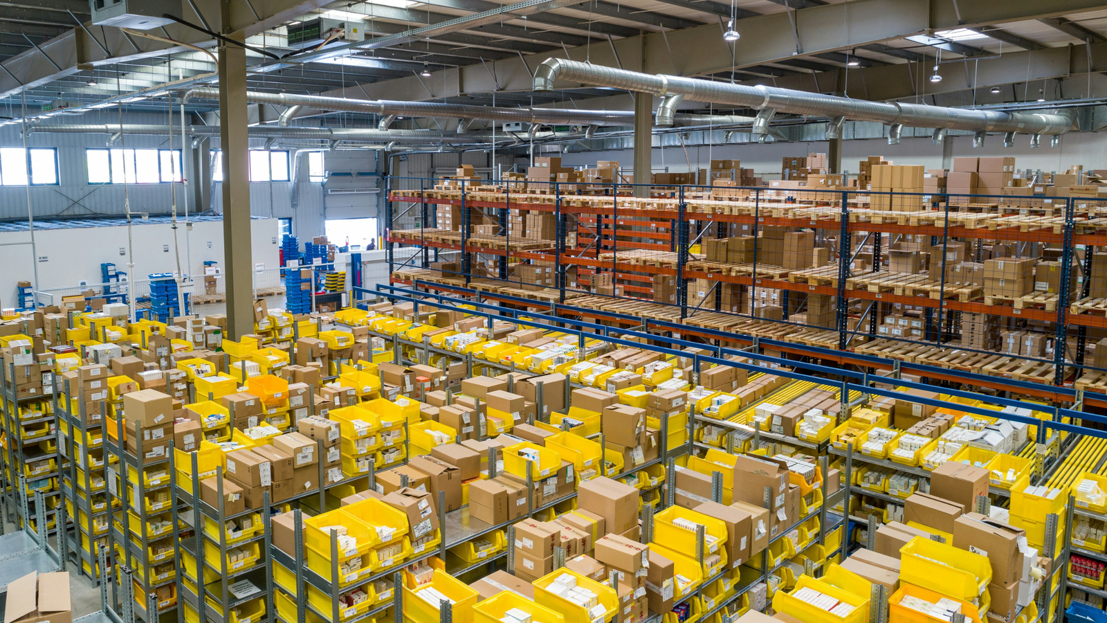 Wide view of a distribution warehouse with racked pallets