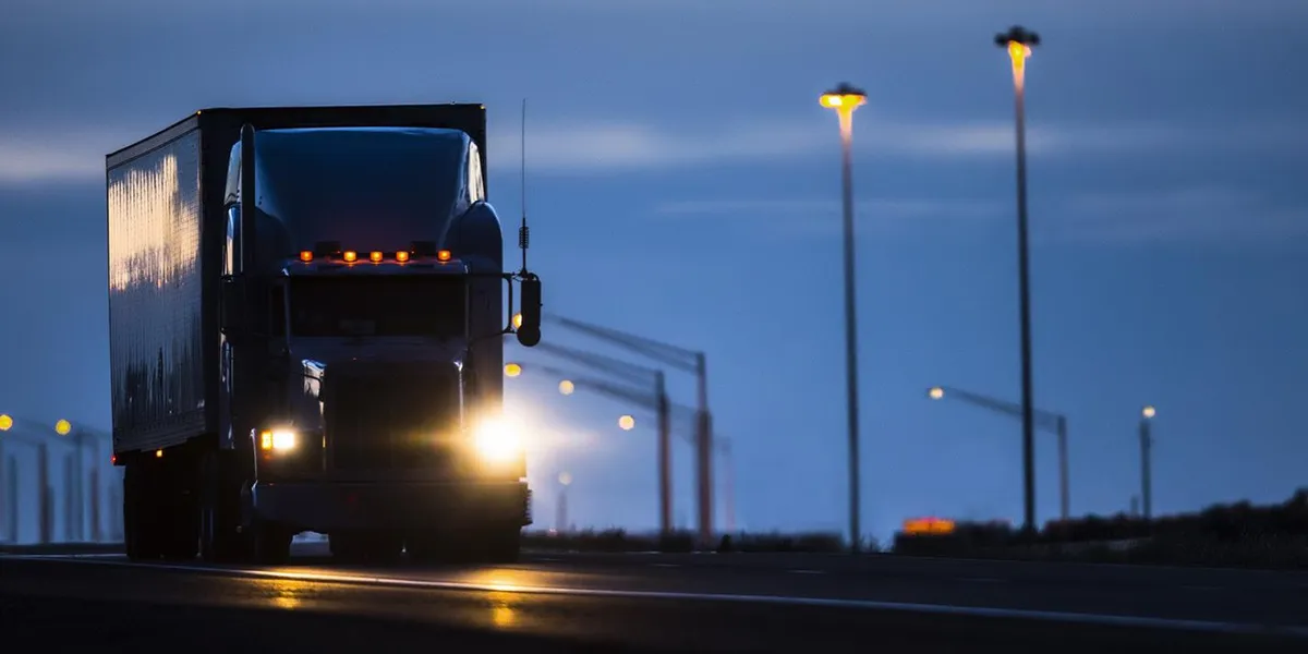 Tractor trailer running on the highway at night