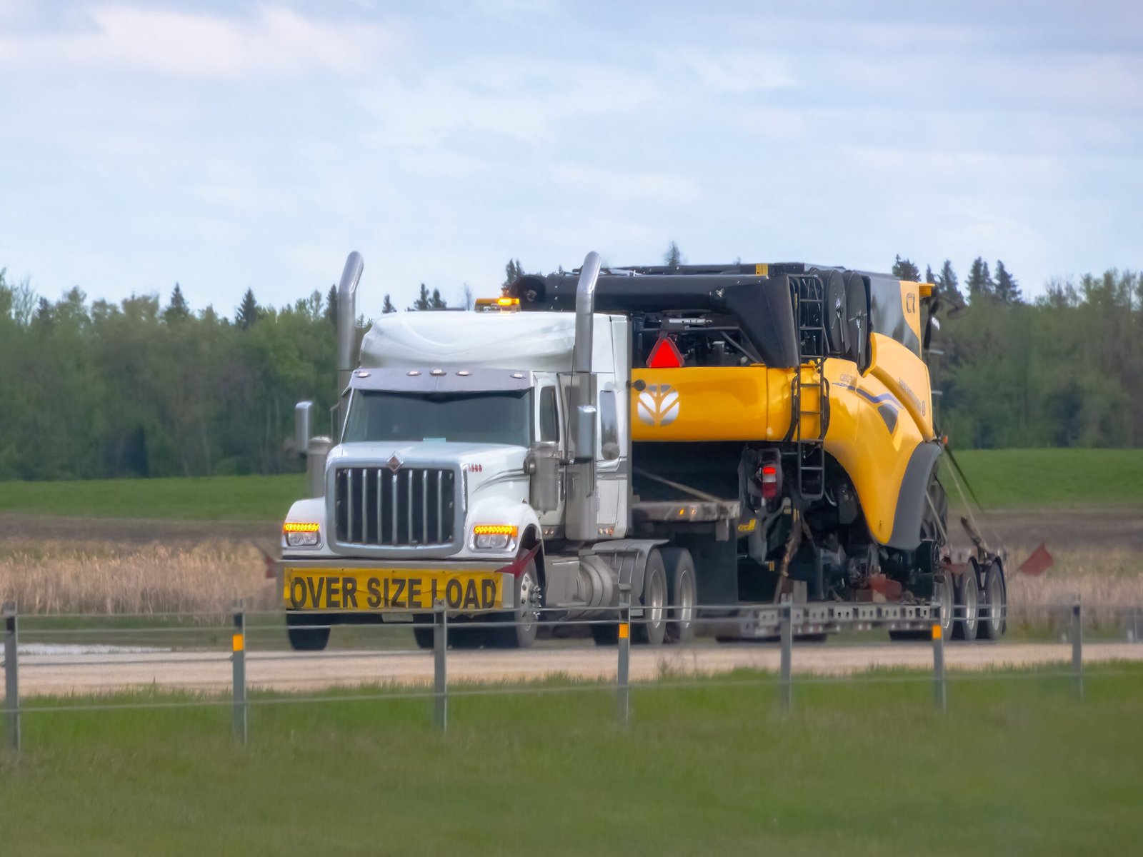 Heavy haul tractor pulling an oversize load on a step deck trailer